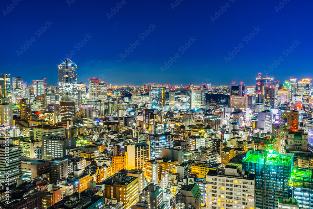 Asia business concept for real estate and corporate construction - panoramic urban city skyline aerial view under twilight sky and neon night with highway junction in hamamatsucho, tokyo, Japan