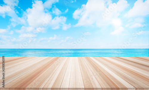Design concept - Empty wood table top with sea and cloud background for display or montage product