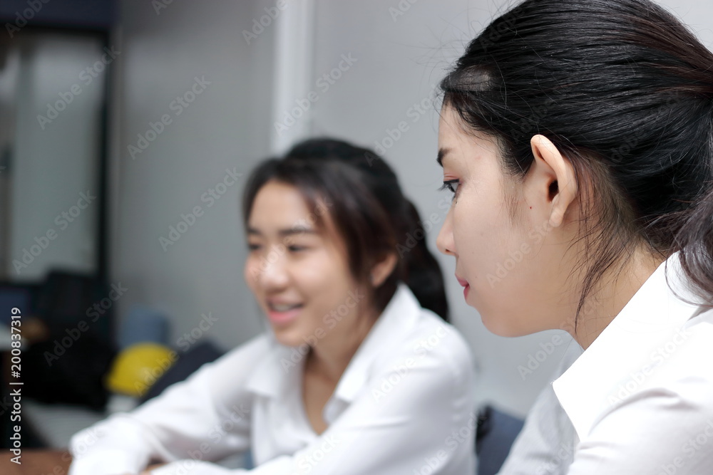 Envious young Asian business woman conflict with her colleague in office. Crisis and confrontation business concept. Envious young Asian business woman conflict with her colleague in office. Crisis and confrontation business concept.
