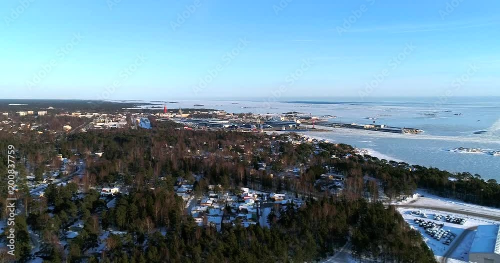 Frozen cityscape, Cinema 4k aerial sideway view of a icy Hanko city, on a cold sunny winter day, in Tulliniemi, Uusimaa, Finland Frozen cityscape, Cinema 4k aerial sideway view of a icy Hanko city, on a cold sunny winter day, in Tulliniemi, Uusimaa, Finland