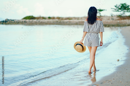 beautiful girl walking along the beach