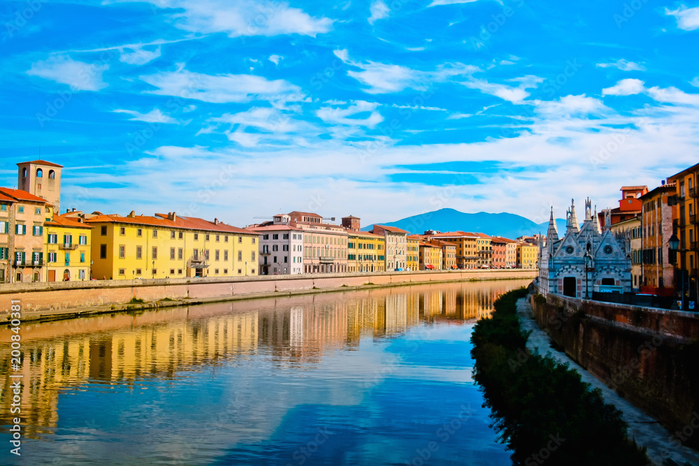 Church Santa Maria della Spina on the Arno river embankment in Pisa with colorful old houses, Italy, Europe.    