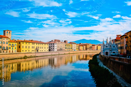 Church Santa Maria della Spina on the Arno river embankment in Pisa with colorful old houses, Italy, Europe. 