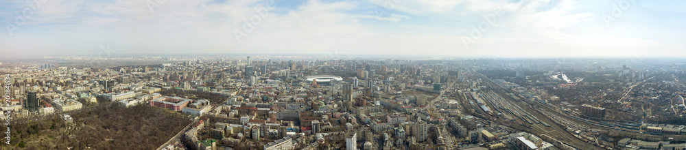 Panoramic photo of the city of Kiev with the stadium Olympic against the blue sky.