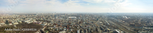 Panoramic photo of the city of Kiev with the stadium Olympic against the blue sky. © artjazz