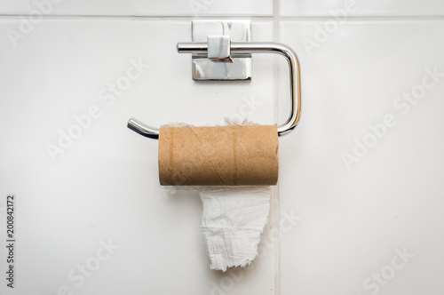 Empty toilet paper roll in public restroom
