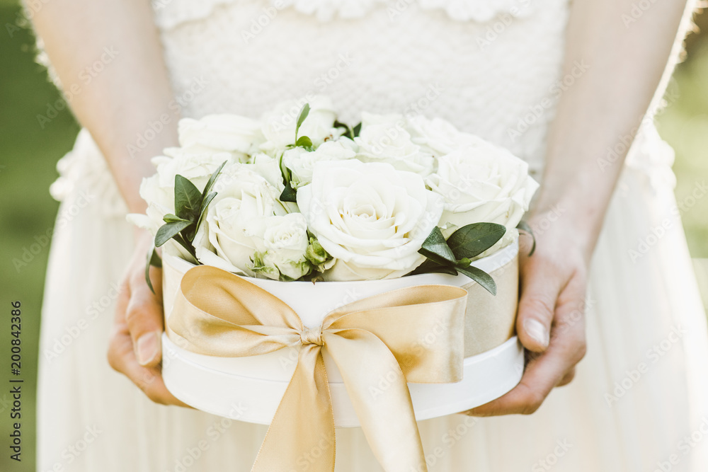 Bridesmaid holding a box of roses. Rose box. Beautiful gift with white roses. Bridesmaid holding a box of roses. Rose box. Beautiful gift with white roses.