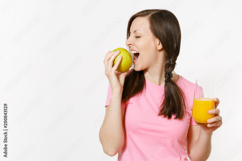 Beautiful fun happy woman holding in hands green apple and orange fresh juice in glass isolated on white background. Proper nutrition, dieting concept. Copy space for advertisement. Advertising area. Beautiful fun happy woman holding in hands green apple and orange fresh juice in glass isolated on white background. Proper nutrition, dieting concept. Copy space for advertisement. Advertising area.
