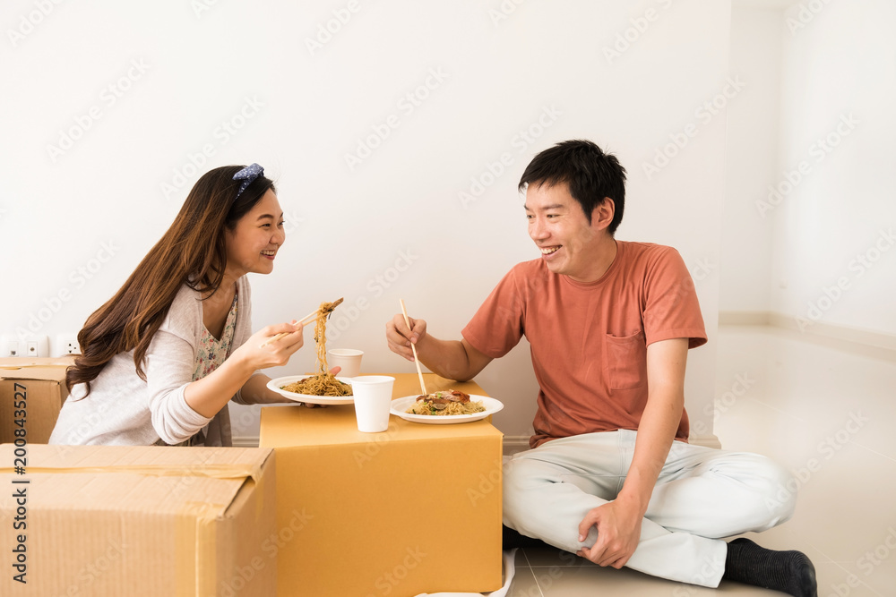 couple eat noodle at new moving house couple eat noodle at new moving house