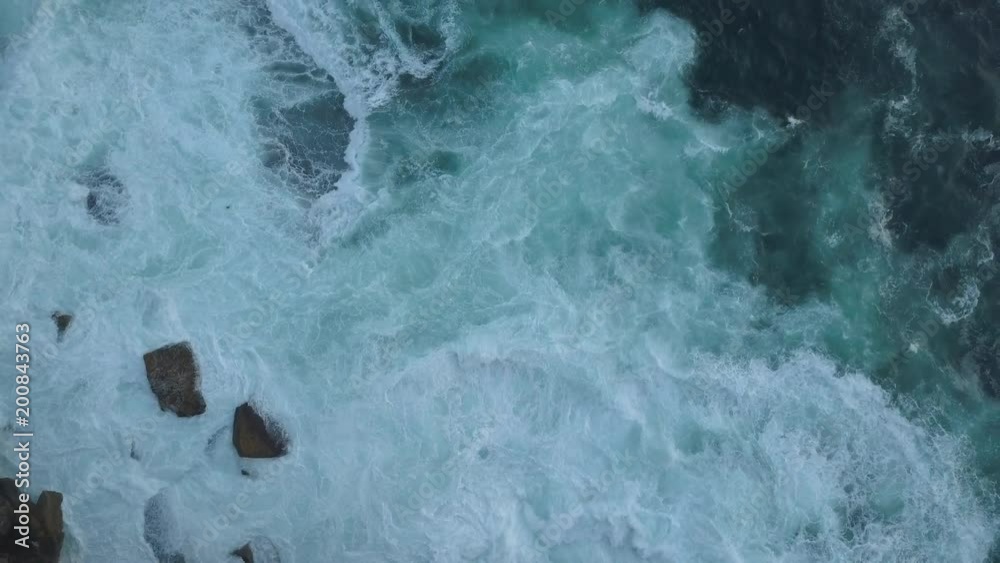 Aerial view of rocky water with waves breaking. Aerial view of rocky water with waves breaking.