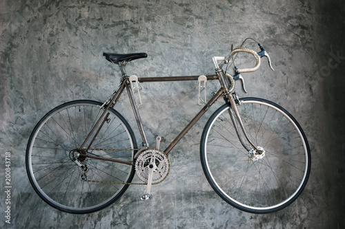 Antique bicycle on grunge gray wall