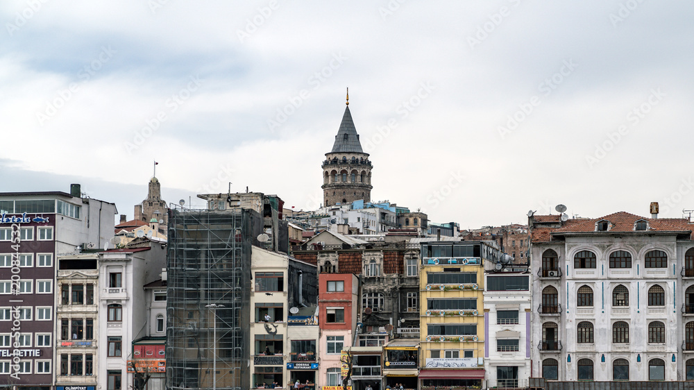 Istanbul cityscape in Turkey with Galata Tower, 14th-century city landmark in the middle. Istanbul cityscape in Turkey with Galata Tower, 14th-century city landmark in the middle.