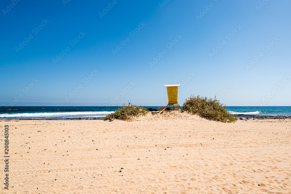 Scenic view of lifeguard yellow hut on the beach Scenic view of lifeguard yellow hut on the beach