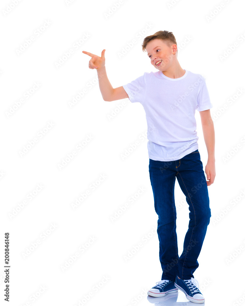 A beautiful little school boy points to something. A beautiful little school boy points to something.