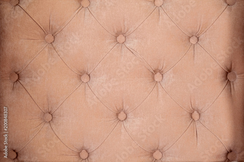 Background of velvet fabric brown sofa close up