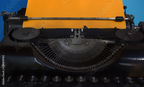 Obraz na plátně Old typewriter with orange paper ready for writing