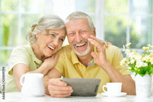  beautiful senior couple using tablet