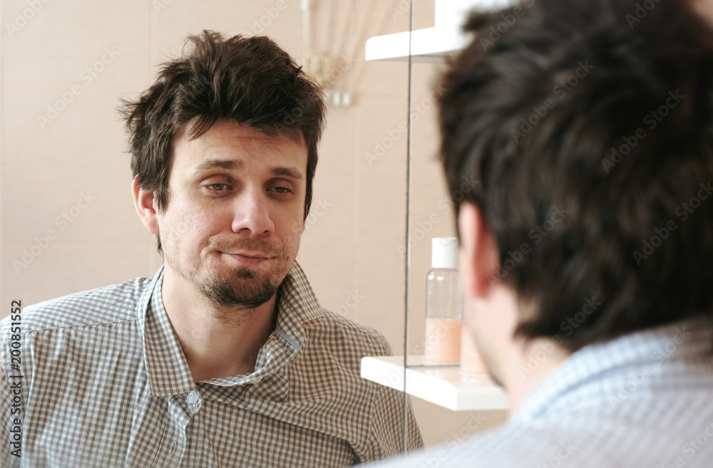 Tired Man Who Has Just Woken Up Looks At His Reflection In The Mirror And Sees His Scruffy