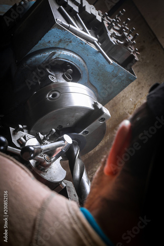 Metal worker working on lathe