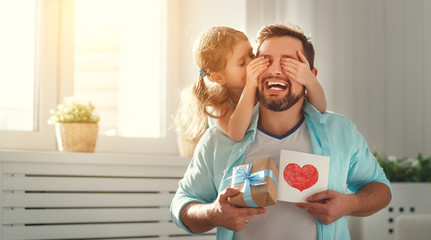 Father's day. Happy family daughter hugging dad and laughs