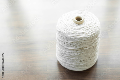 White packing rope on wooden background.