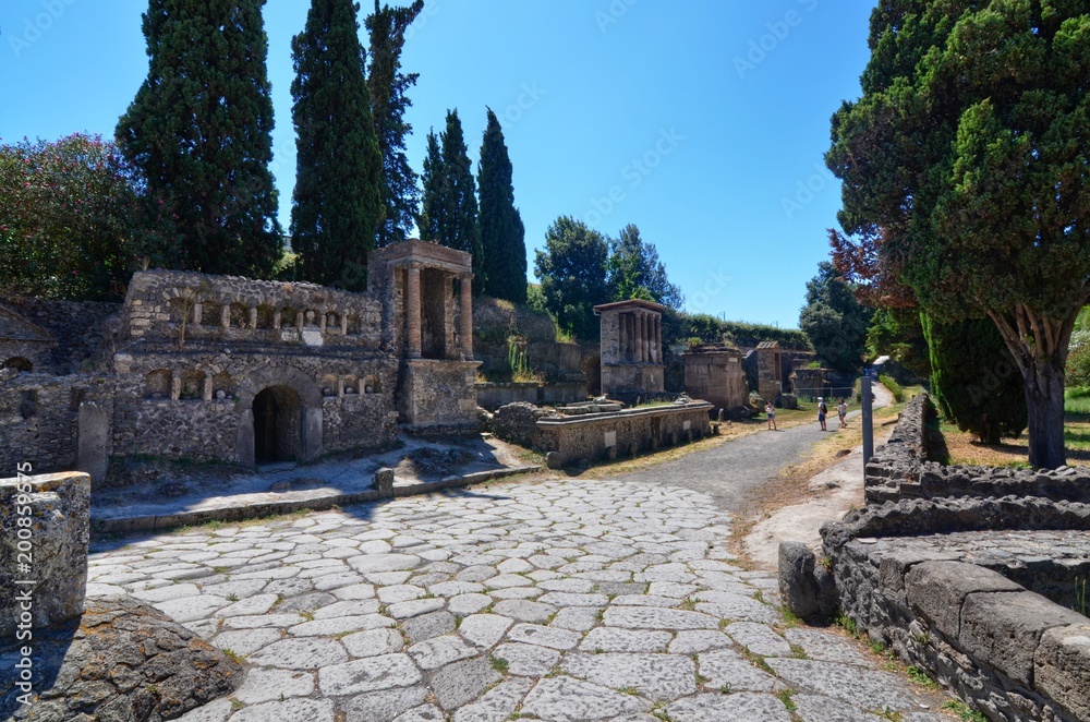 Pompeii, Naples region Campania August 16 2016. The famous archaeological site of Pompeii UNESCO heritage. Crowd of tourists under the scorching sun visit the ancient Roman villas.
