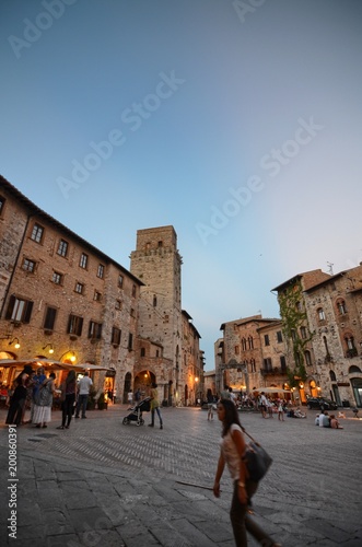 Fototapeta Naklejka Na Ścianę i Meble -  San Gimignano, Italy, Tuscany region. August 14 2016. The historic center of San Gimignano, a typical medieval village in Tuscany. Narrow streets, numerous stone towers characterize the urban landscap