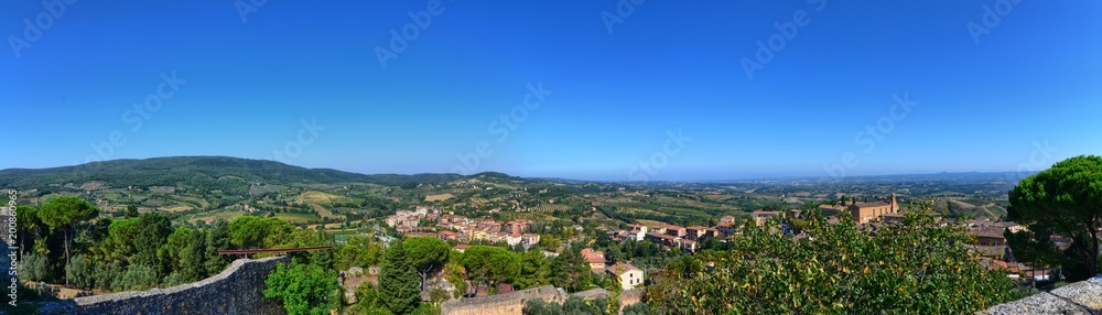 San Gimignano, Italy, Tuscany region. August 14 2016. Landscape seen from the top of San Gimignano towards the valley. Green hills alternate with vineyards and fields cultivated in the countryside.