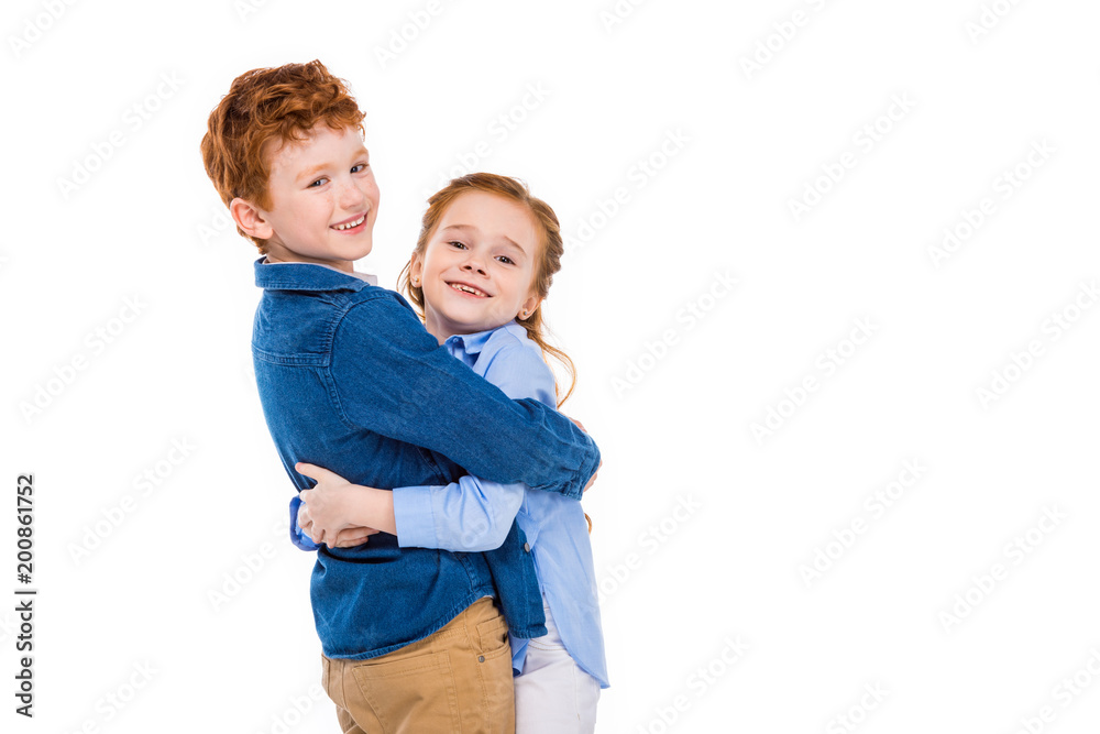 adorable redhead children hugging and smiling at camera isolated on white adorable redhead children hugging and smiling at camera isolated on white