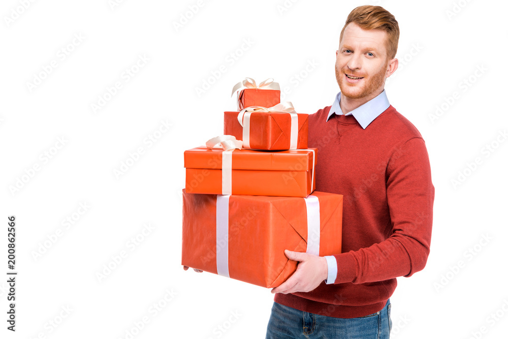 handsome bearded redhead man holding presents and smiling at camera isolated on white handsome bearded redhead man holding presents and smiling at camera isolated on white