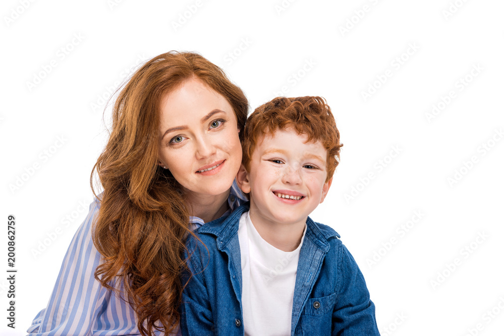 happy red haired mother and son smiling at camera isolated on white happy red haired mother and son smiling at camera isolated on white