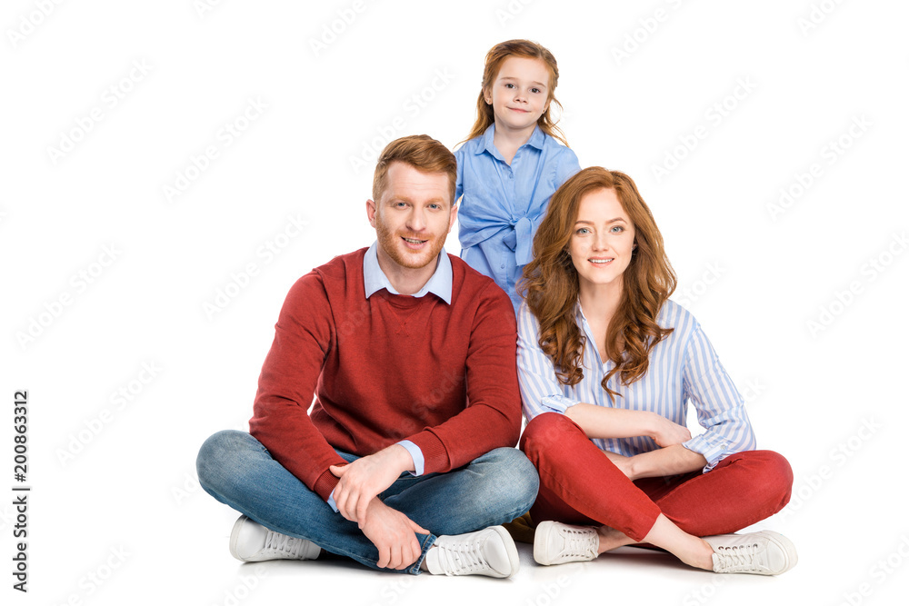 happy redhead family with one child smiling at camera isolated on white happy redhead family with one child smiling at camera isolated on white