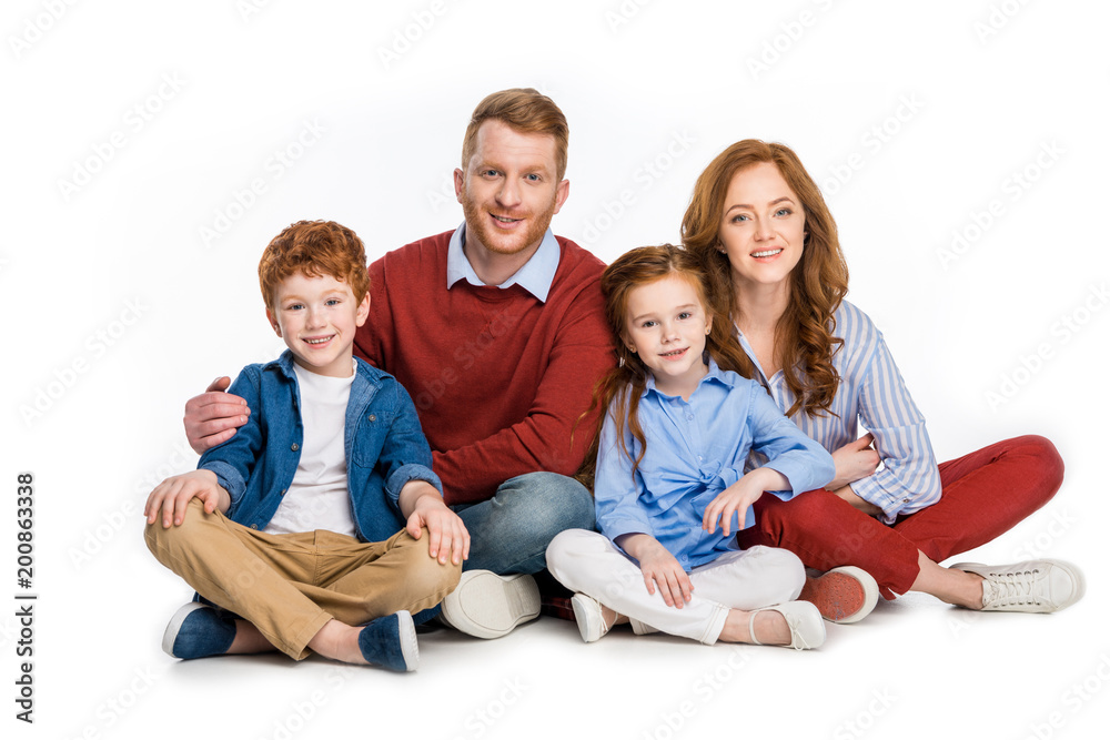happy family with two kids sitting together and smiling at camera isolated on white happy family with two kids sitting together and smiling at camera isolated on white