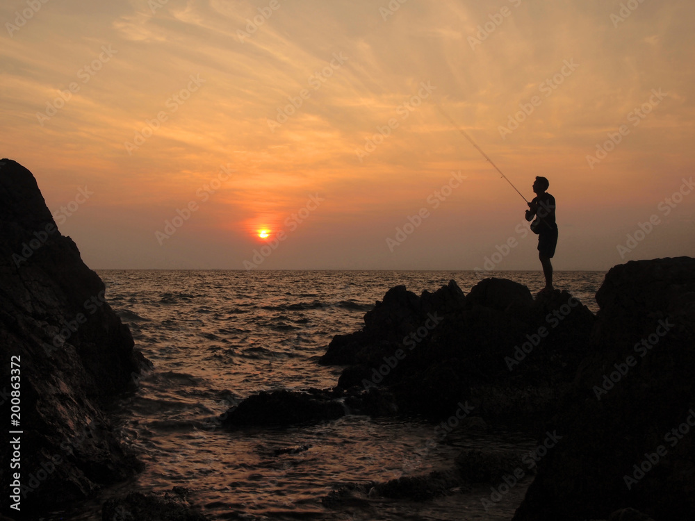 fishermen silhouette at sunset