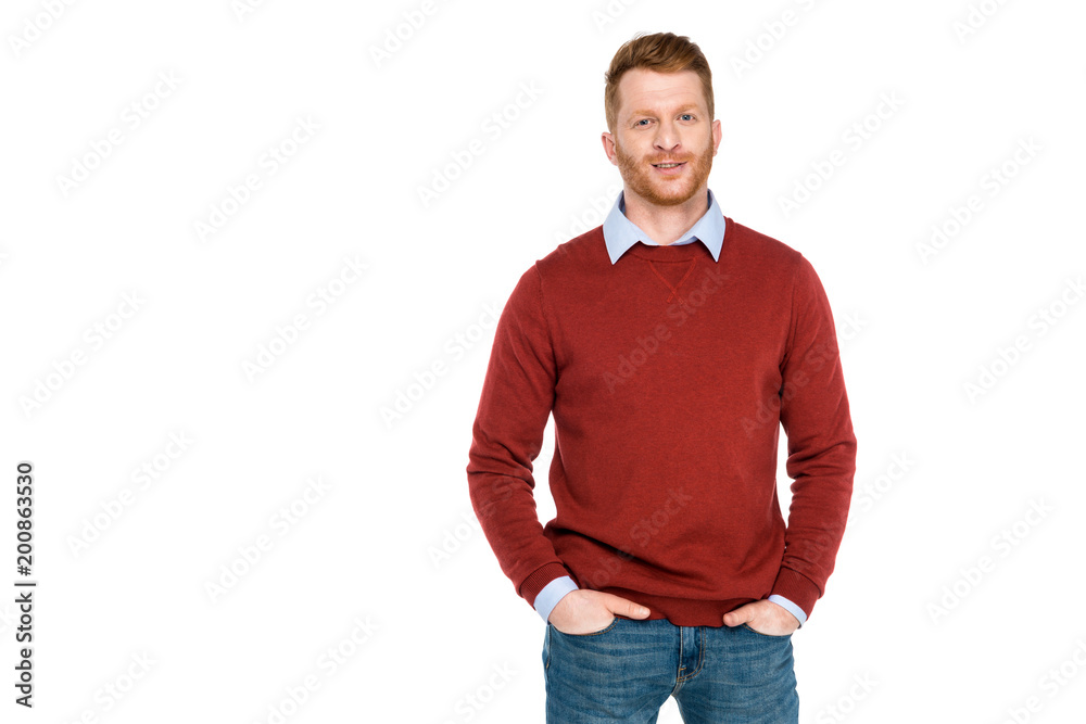 portrait of handsome redhead man standing with hands on pockets and smiling at camera isolated on white portrait of handsome redhead man standing with hands on pockets and smiling at camera isolated on white