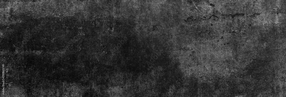 Textur einer fast schwarzen und alten Betonwand, auf die leichtes Licht fällt als Hintergrund