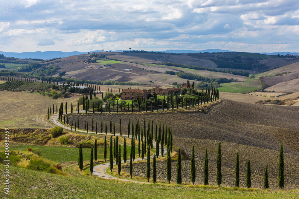 Landscape of hills, country road, cypresses trees and rural houses,Tuscany , rural Italy Landscape of hills, country road, cypresses trees and rural houses,Tuscany , rural Italy