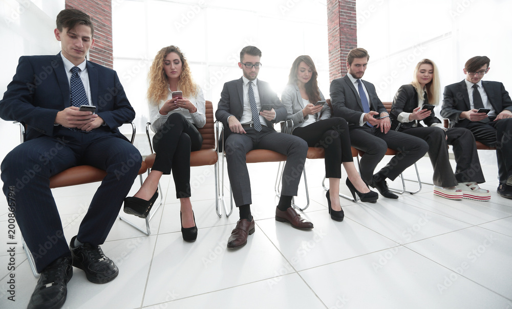 employees using smartphones in the office. employees using smartphones in the office.