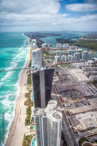 North Miami Beach as seen from helicopter. Skyscrapers along the ocean, aerial view