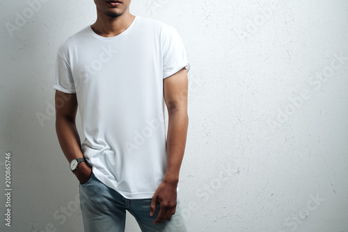 asian man in white blank t-shirt, grunge wall, studio close-up, casual style