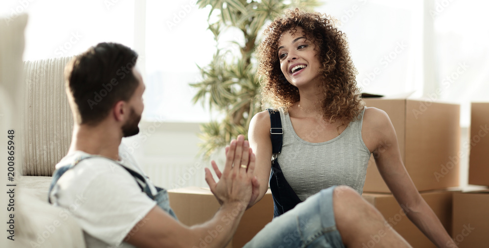 young couple giving each other five with a new home