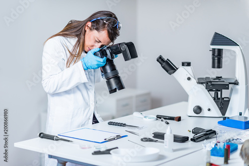 Forensic scientist examining murder weapon photo