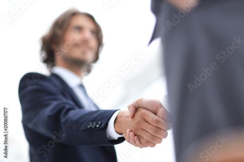 Two businessman shaking hands greeting each other