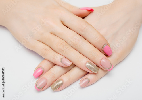 beautiful female hands with pink nail polish on a white background  spa treatments