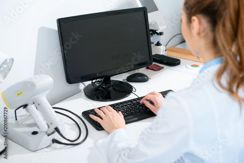 selective focus of female oculist using computer in clinic