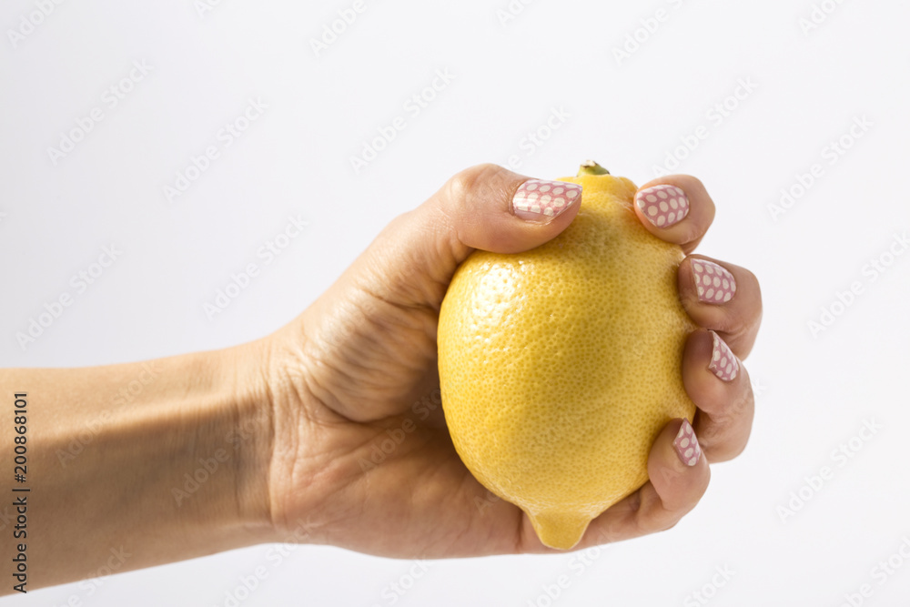 hand squeezing half lemon isolated on white background hand squeezing half lemon isolated on white background