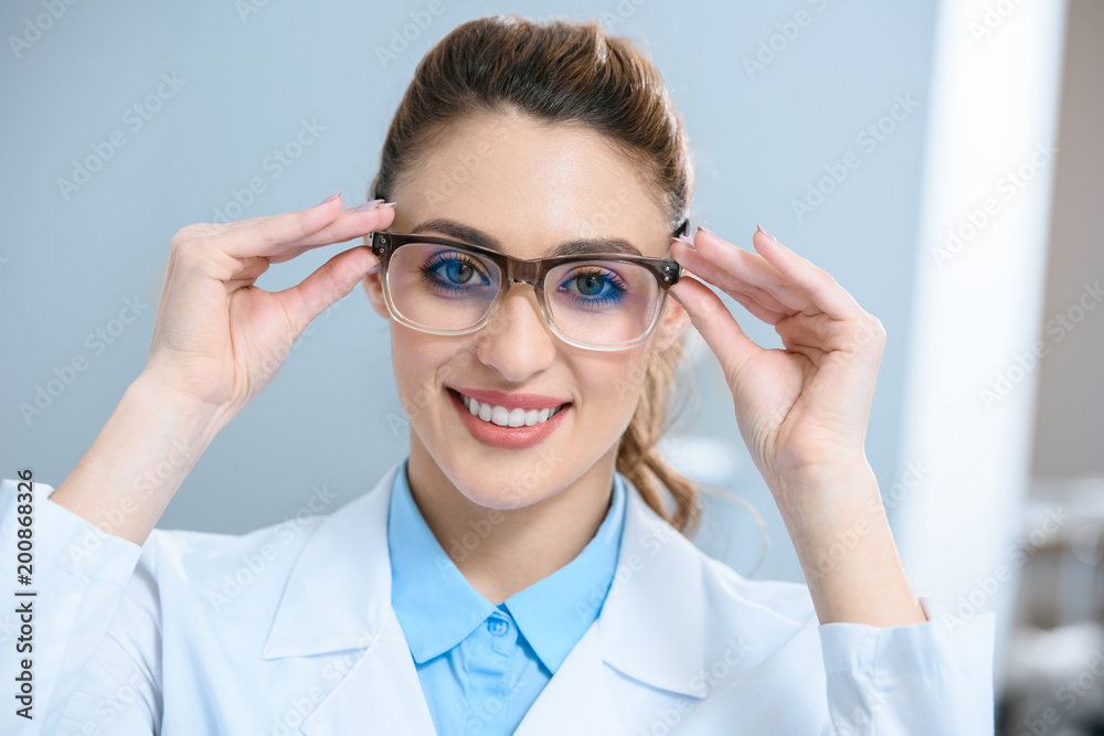 attractive smiling ophthalmologist wearing eyeglasses attractive smiling ophthalmologist wearing eyeglasses