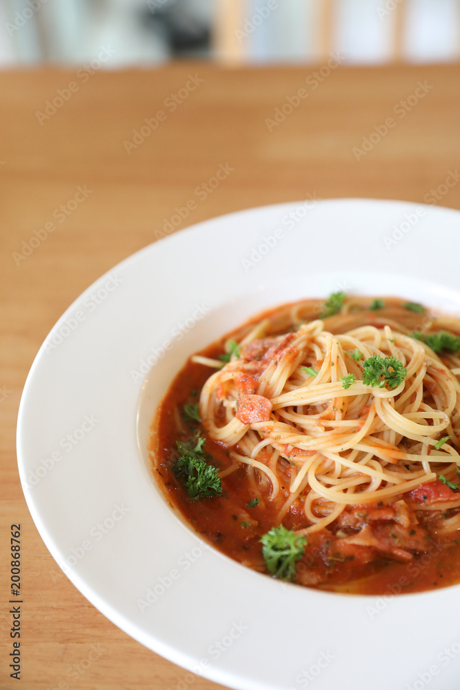 spaghetti Bolognese with minced beef and tomato sauce garnished with parmesan cheese and basil , Italian food