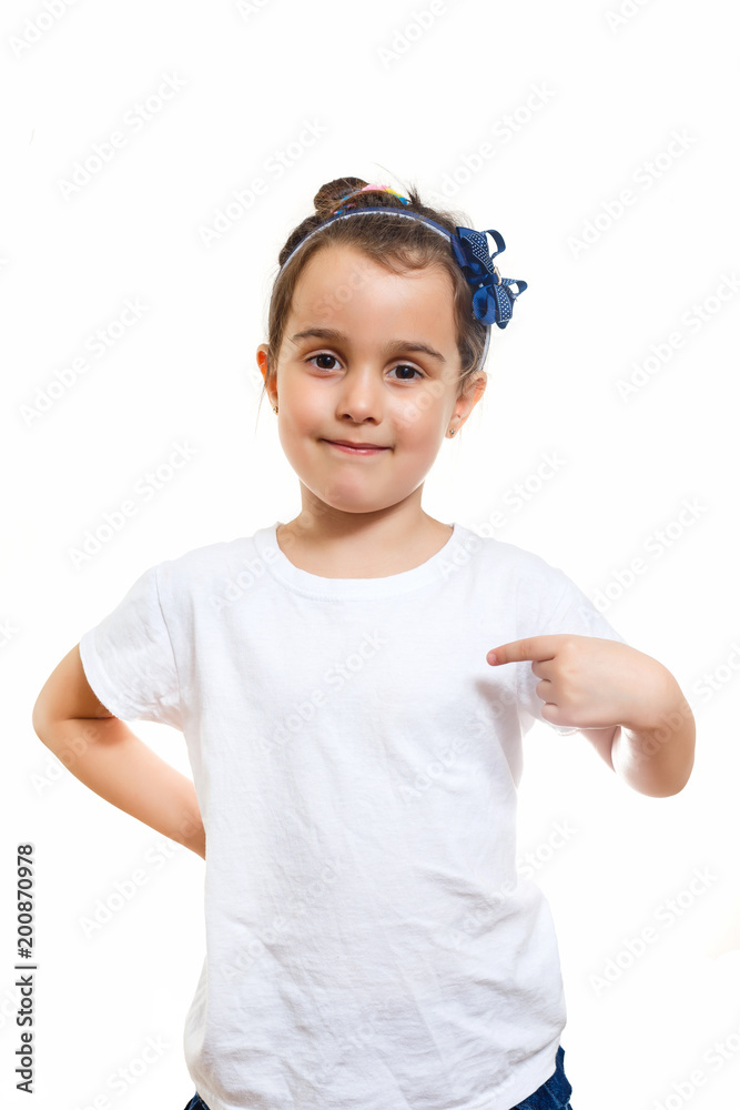 Little girl in casual white t shirt indicates at blank space for logo design Little girl in casual white t shirt indicates at blank space for logo design