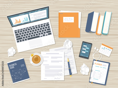 Workplace background. Top view of a wooden table with laptop, books, documents, folder, notepad, calculator, calendar, crumpled paper, tea. Vector illustration 